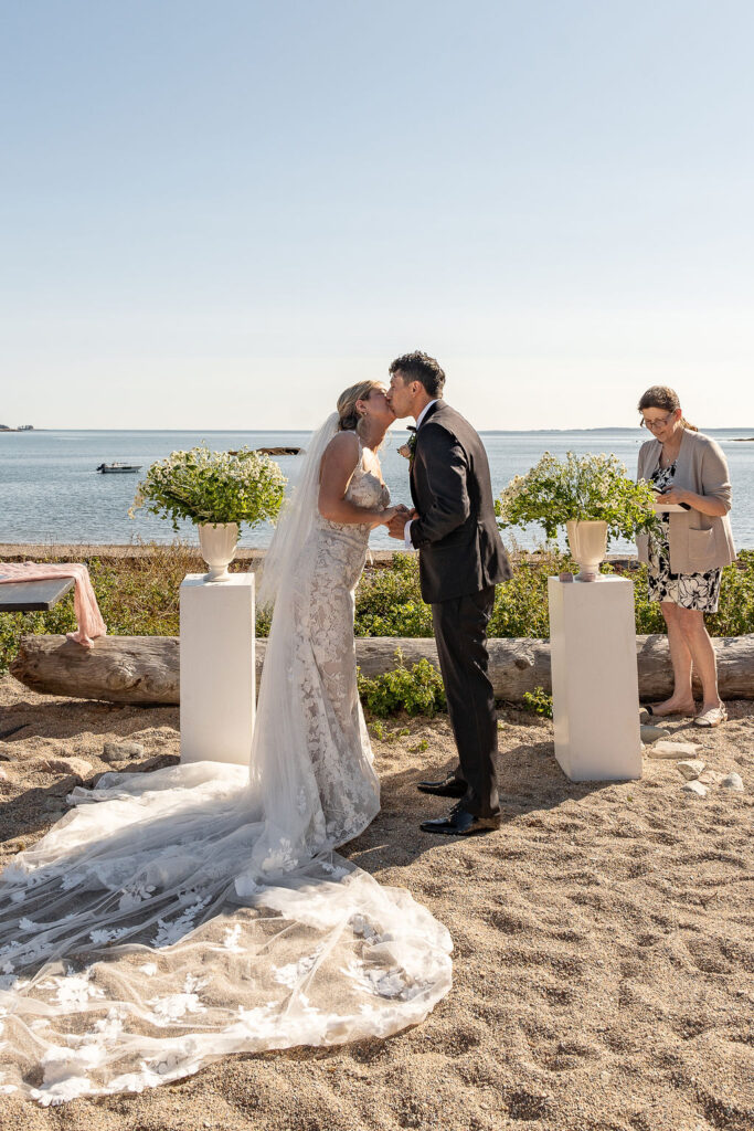 Bride and groom, kissing after their wedding ceremony