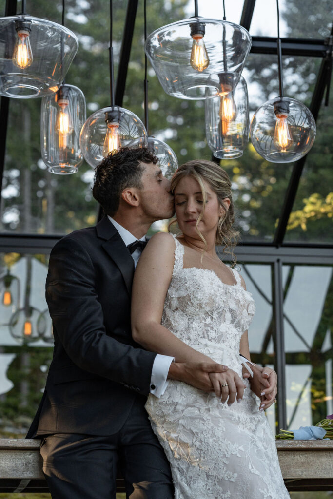Groom, kissing the bride on the cheek