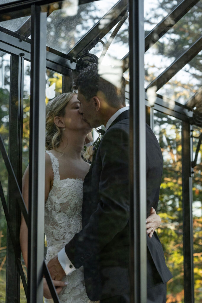 cute portrait of the newlyweds kissing at their reception