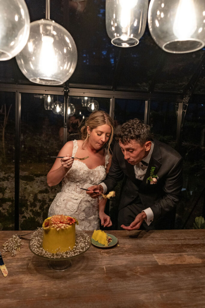 newlyweds trying their wedding cake
